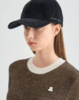 Person wearing a black cap with 'LANVIN' branding on a light gray background