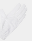 White golf glove with perforated fingers and GB bear logo patch on wrist closure on a light gray background