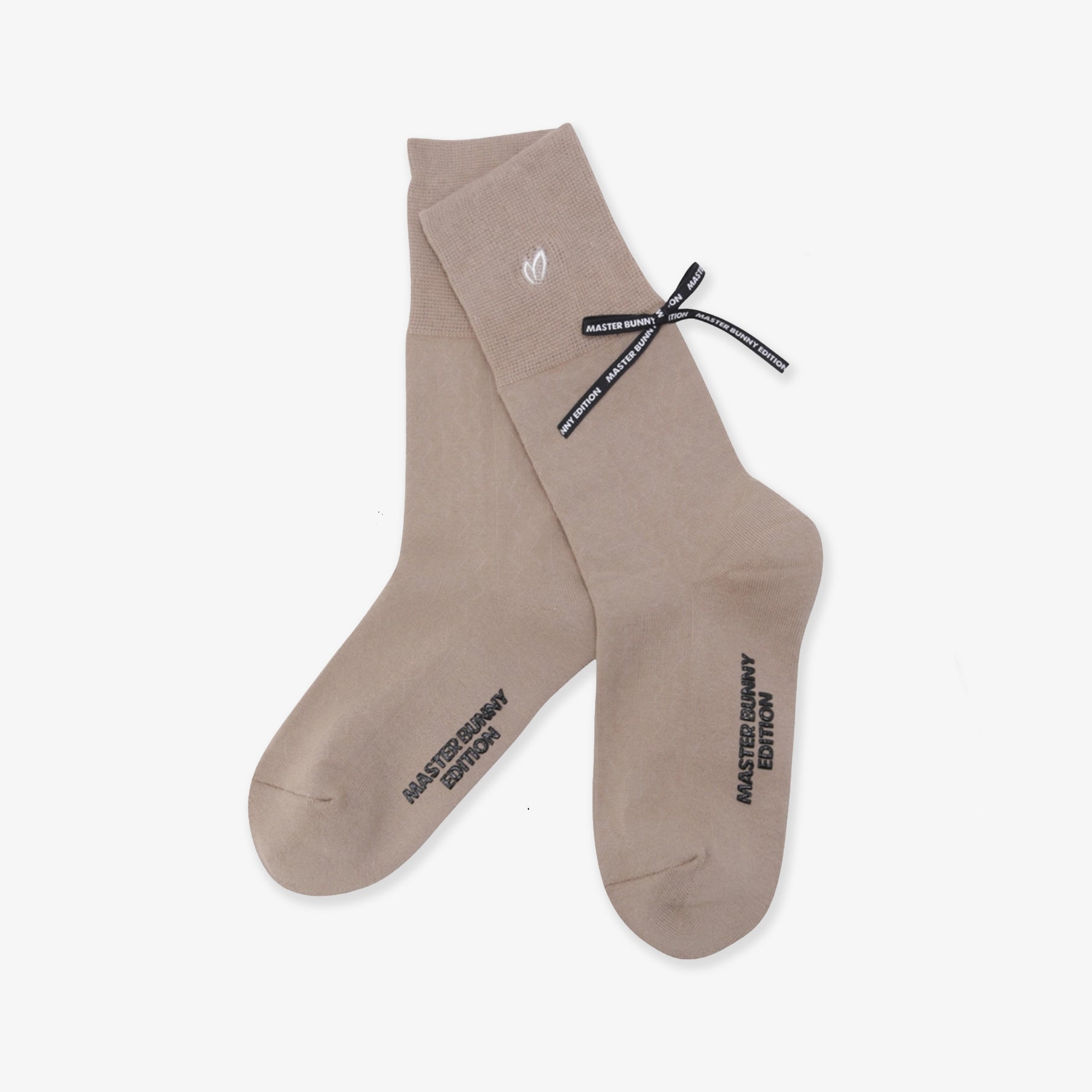 Beige socks with black text and a logo on a white background