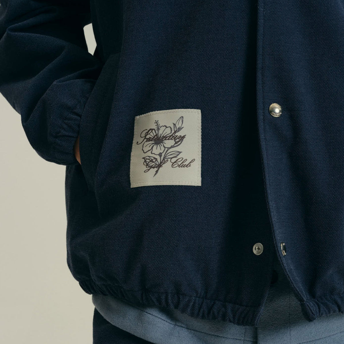 A three-panel collage showing a model wearing a navy blue button-up overshirt and jacket. The top panel shows the front of the navy jacket with a small patch on the pocket.