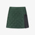 Green quilted skirt with black patch on a white background