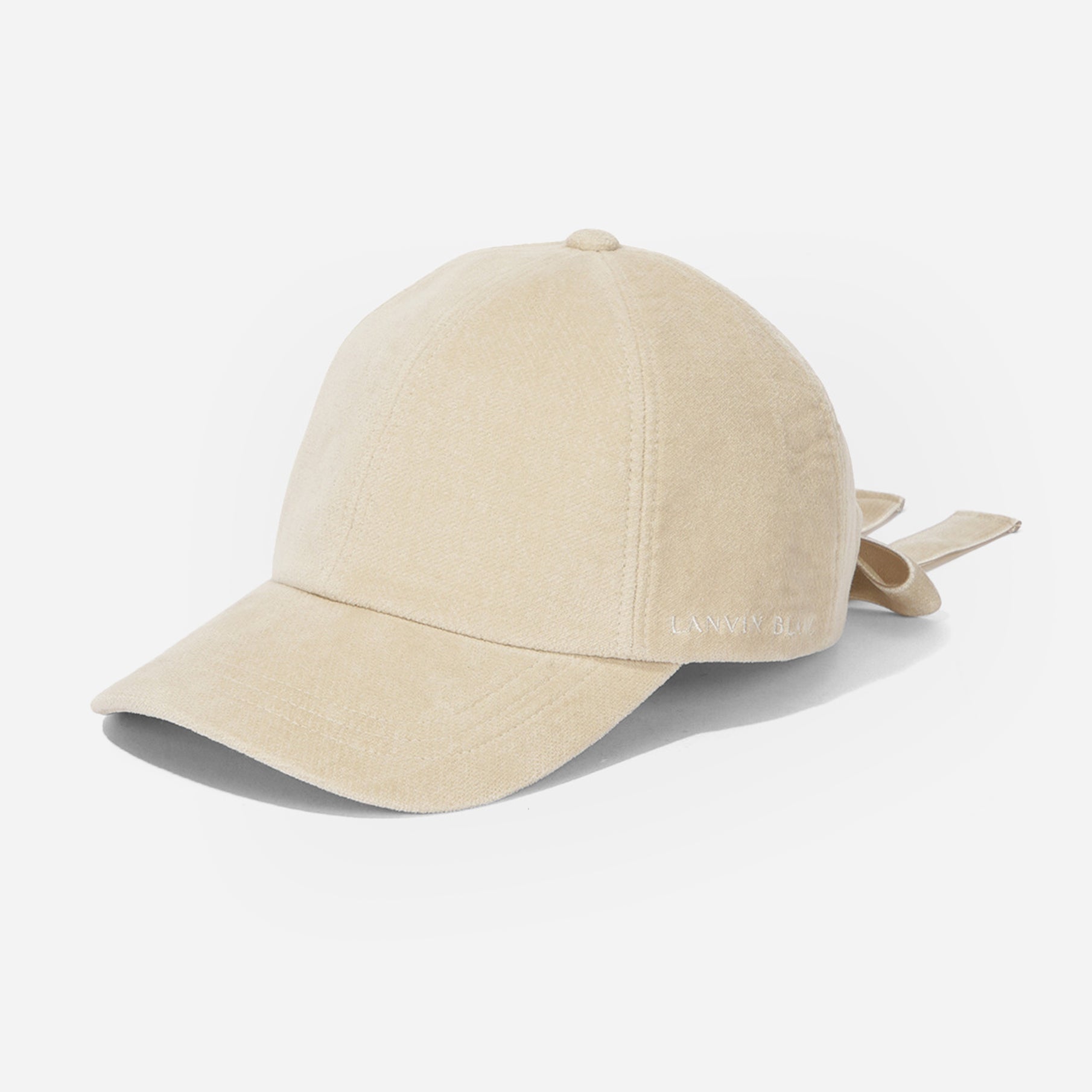 Beige baseball cap with a bow on a white background