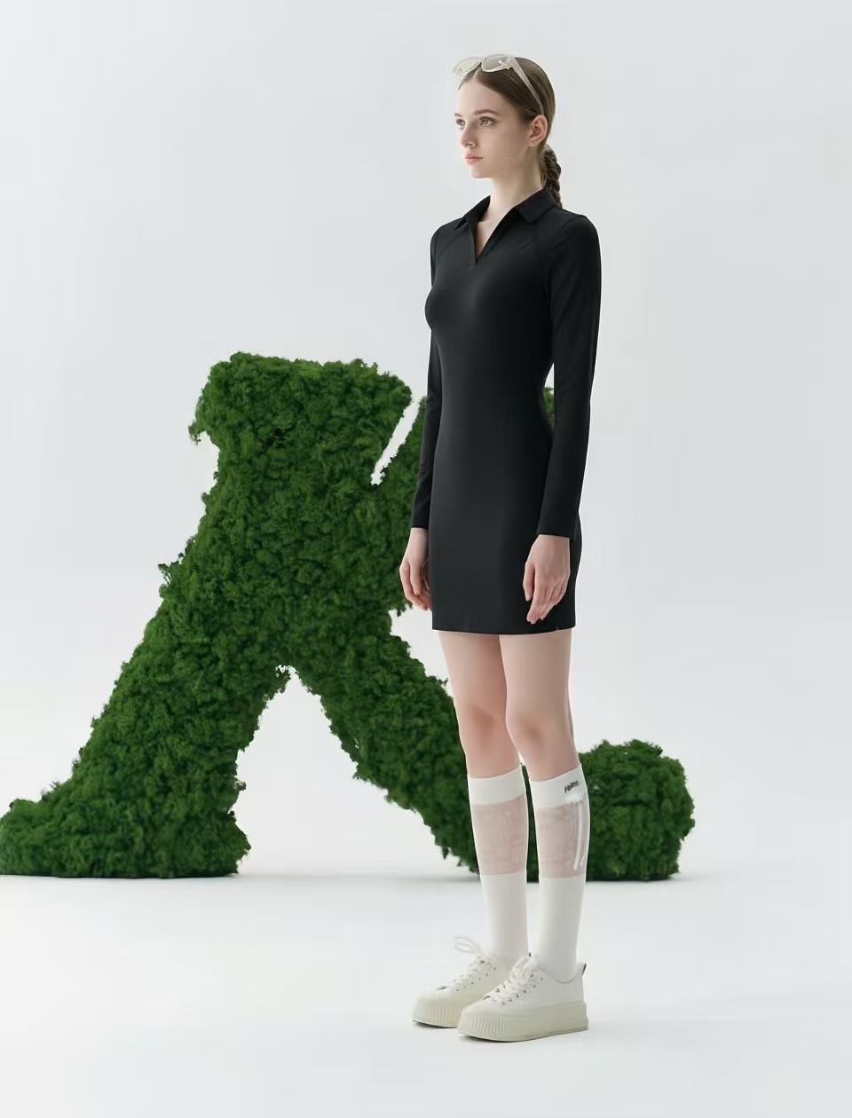 Person wearing a black dress on a white background