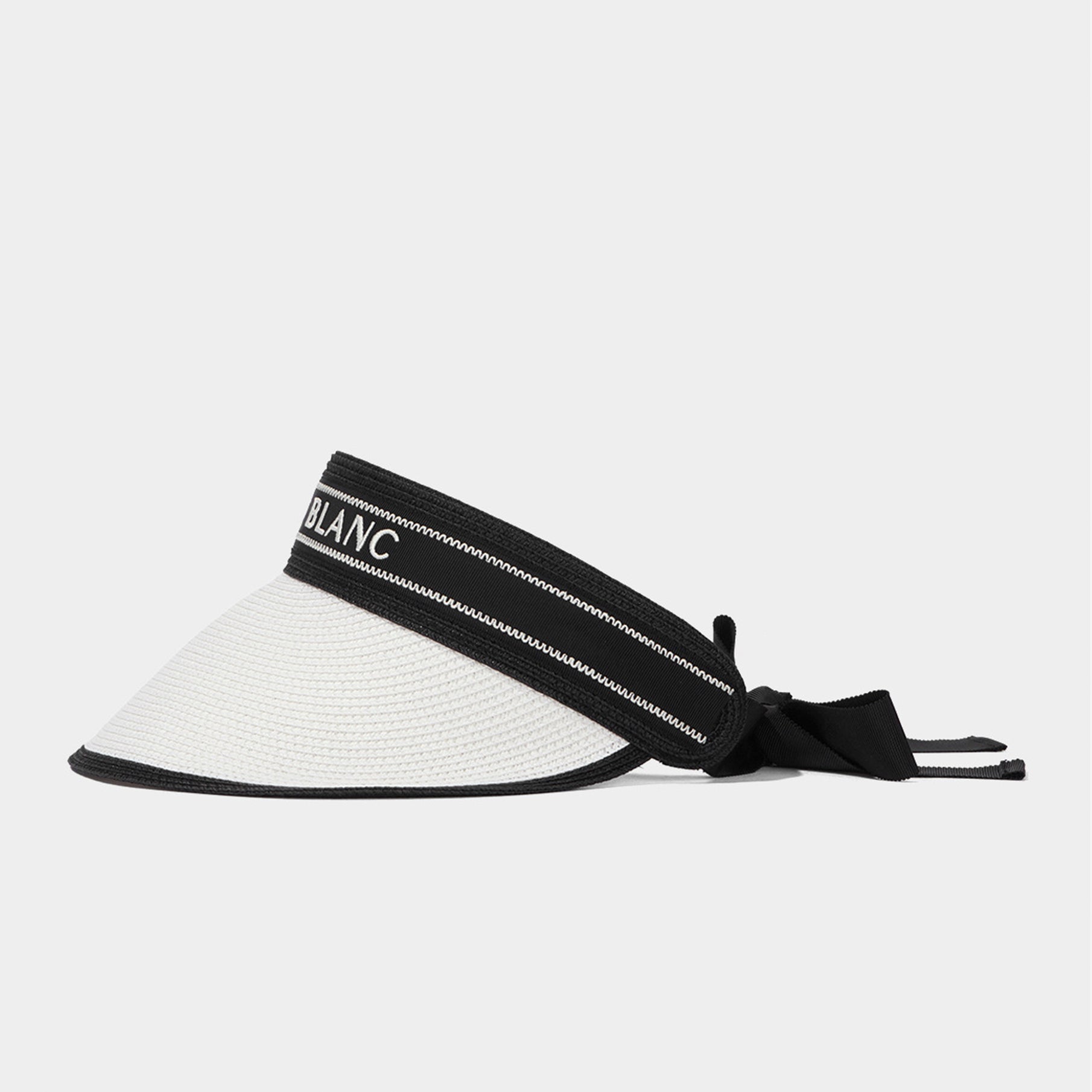 White visor with black strap on a light gray background