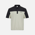 A short-sleeve polo shirt with a colorblock design, featuring a black yoke and collar, and a light beige body and sleeves. The brand name &