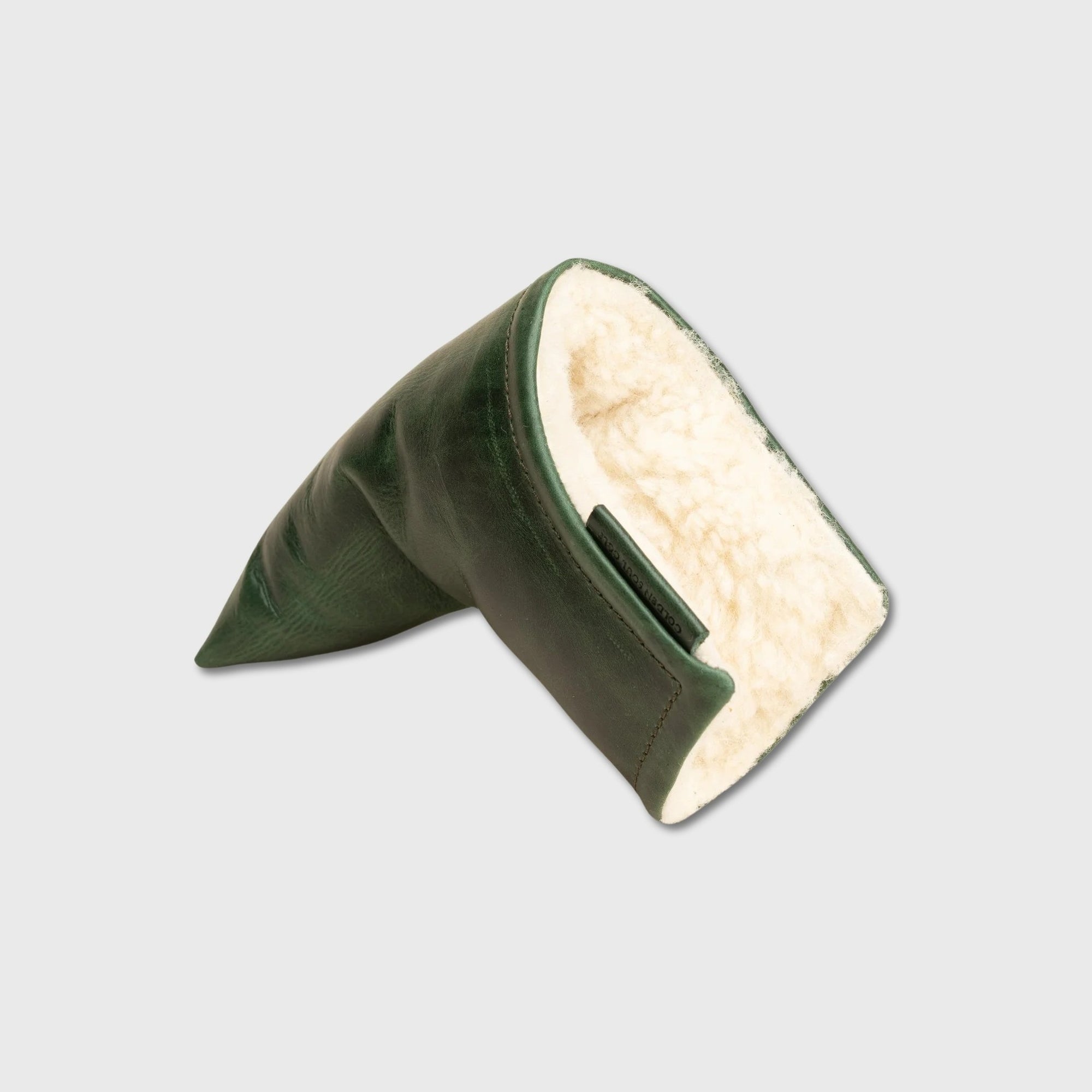 A dark green leather blade putter cover with a cream-colored sherpa lining, shown on a light gray background.