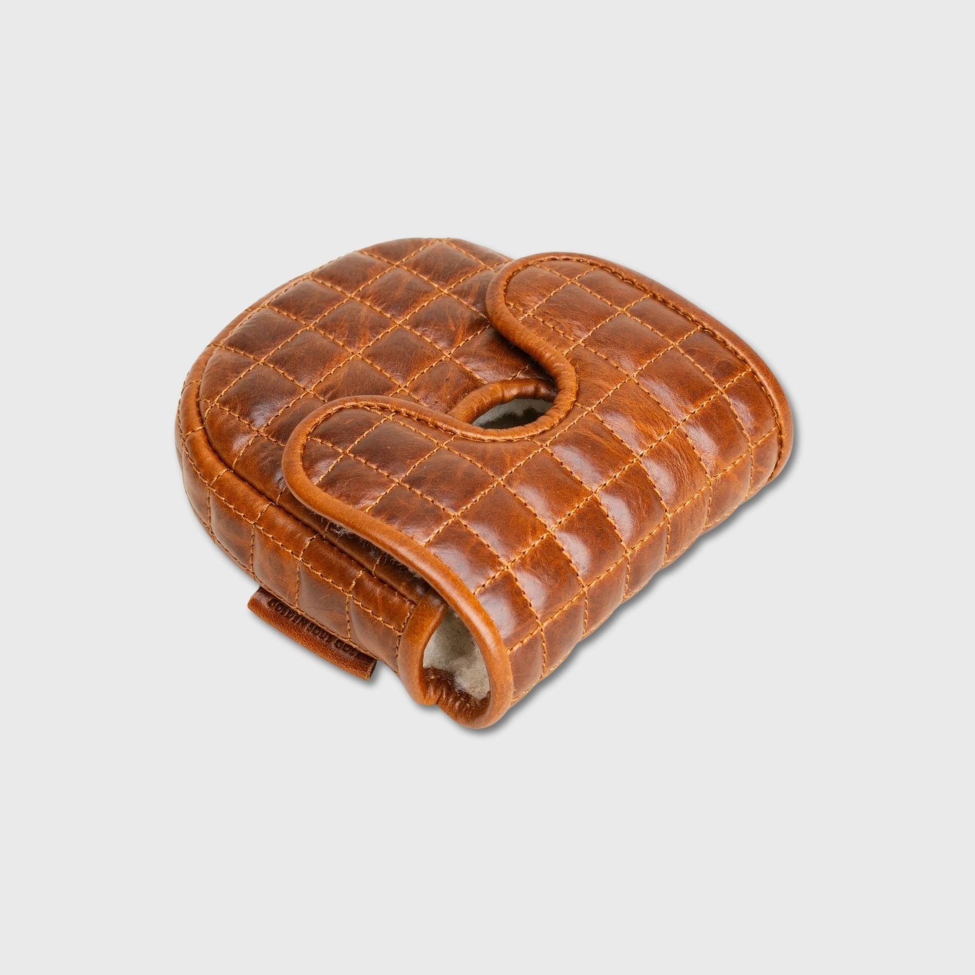 A brown quilted leather DF3 putter cover with a curved, padded design and a central cutout, shown on a light gray background.