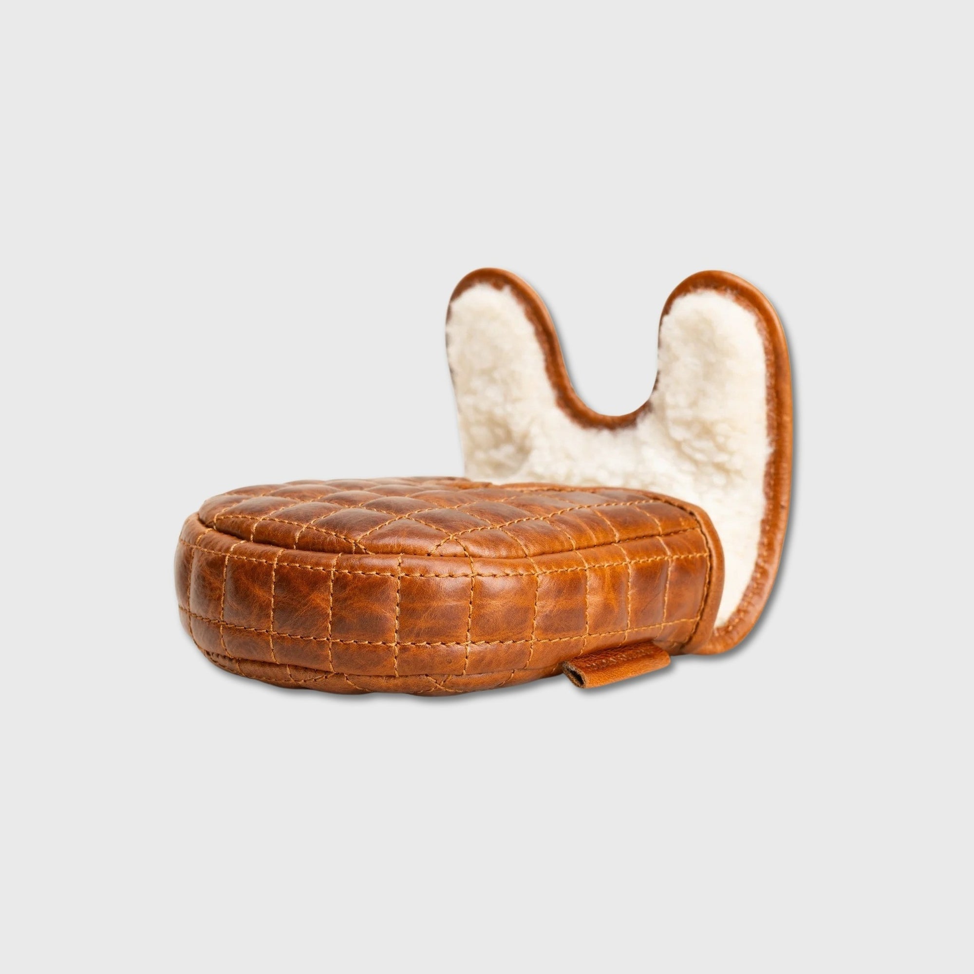 A small brown quilted leather DF3 putter cover with a curved, padded backrest made of cream-colored faux fur, shown on a light gray background.