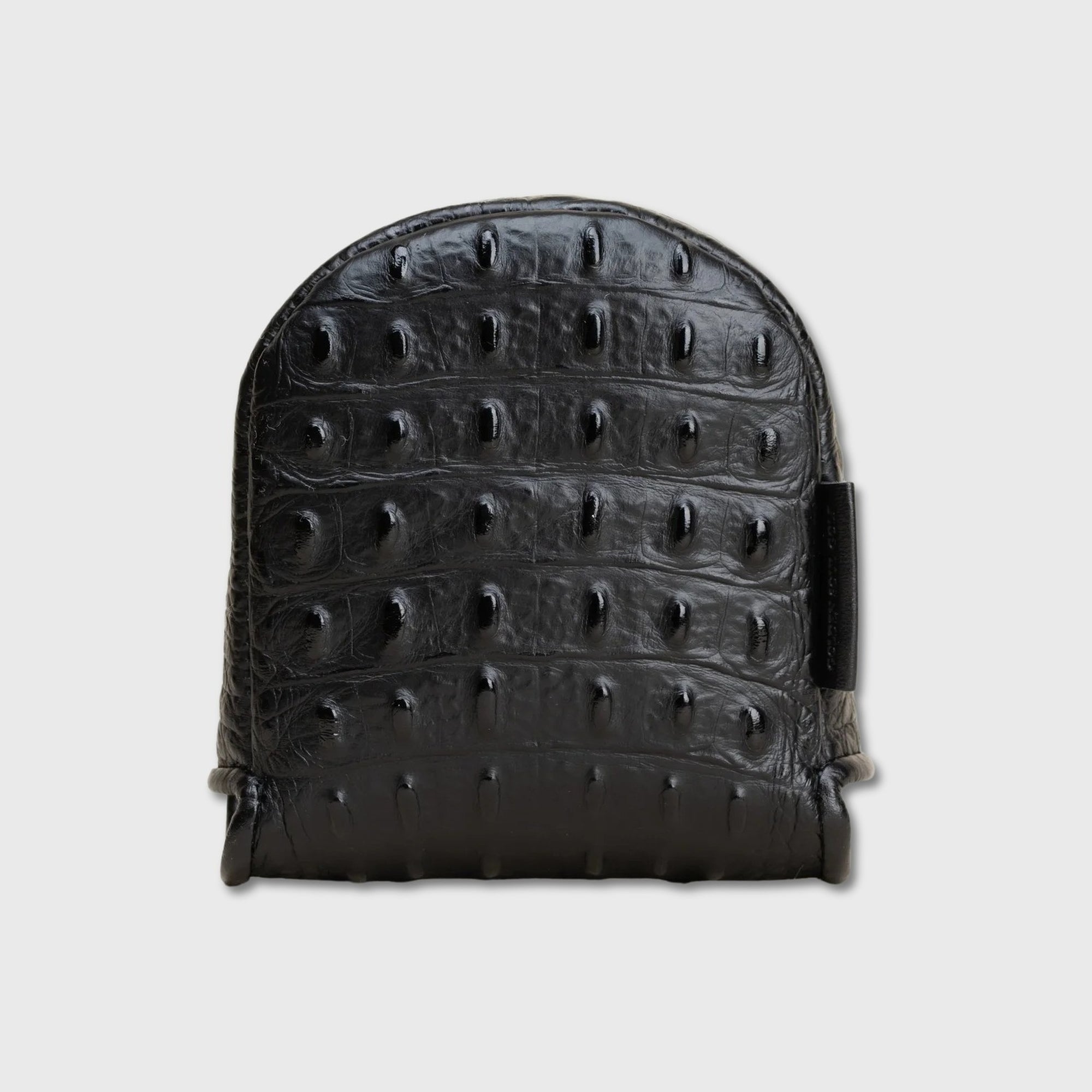 A black crocodile-embossed leather DF3 putter cover with a structured arch shape, shown against a light gray background.