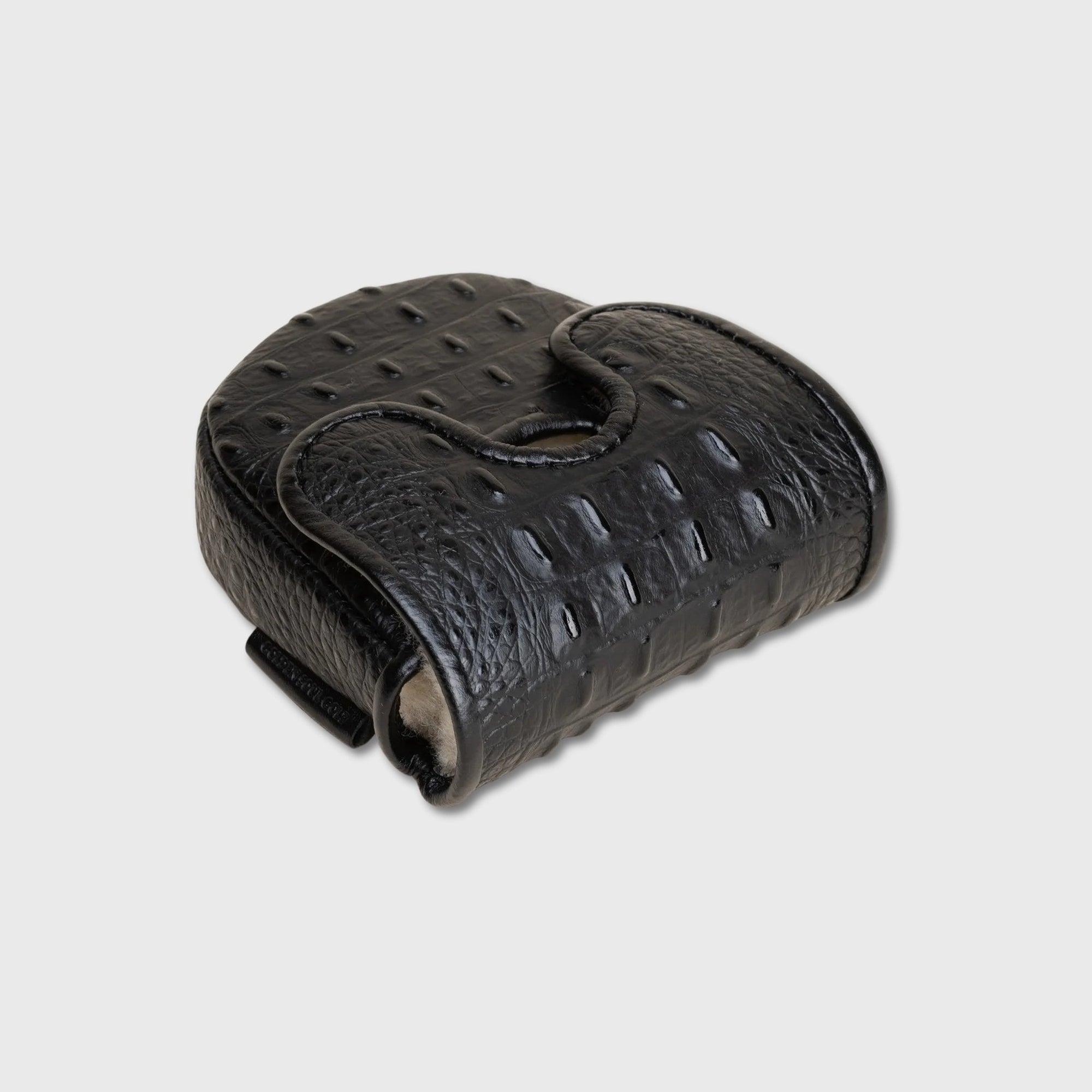 A black textured leatherDF3 putter cover with an alligator or crocodile skin pattern, featuring a curved top handle and a small side tab, shown on a light gray background.