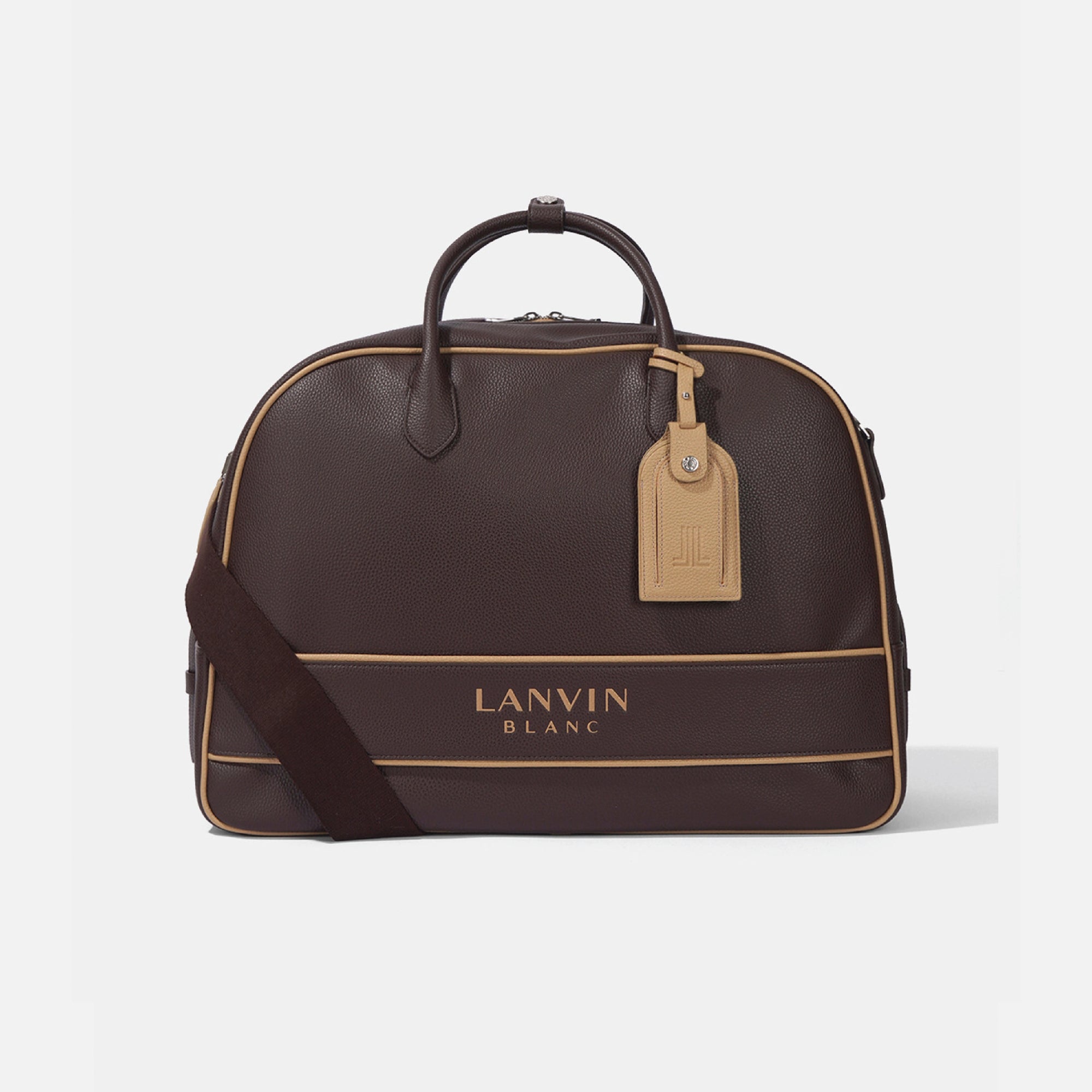 A dark brown leather Lanvin Blanc duffel bag with tan piping, a tan leather luggage tag, and a dark brown shoulder strap, shown on a light gray background.