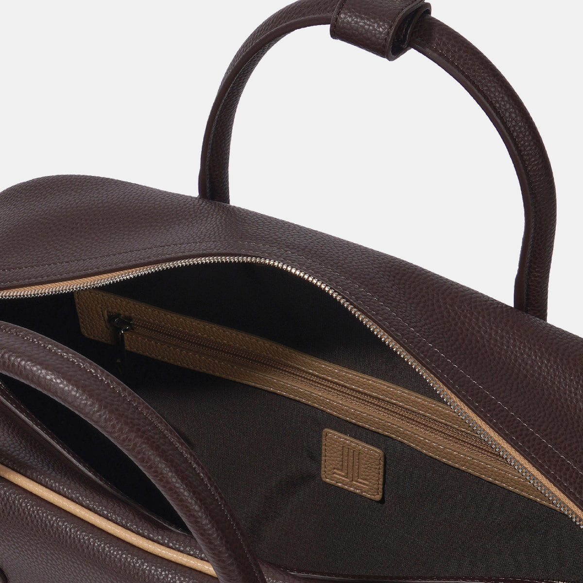 Close-up of a dark brown pebbled leather bag with an open top handle and a zippered interior pocket, shown against a light gray background.