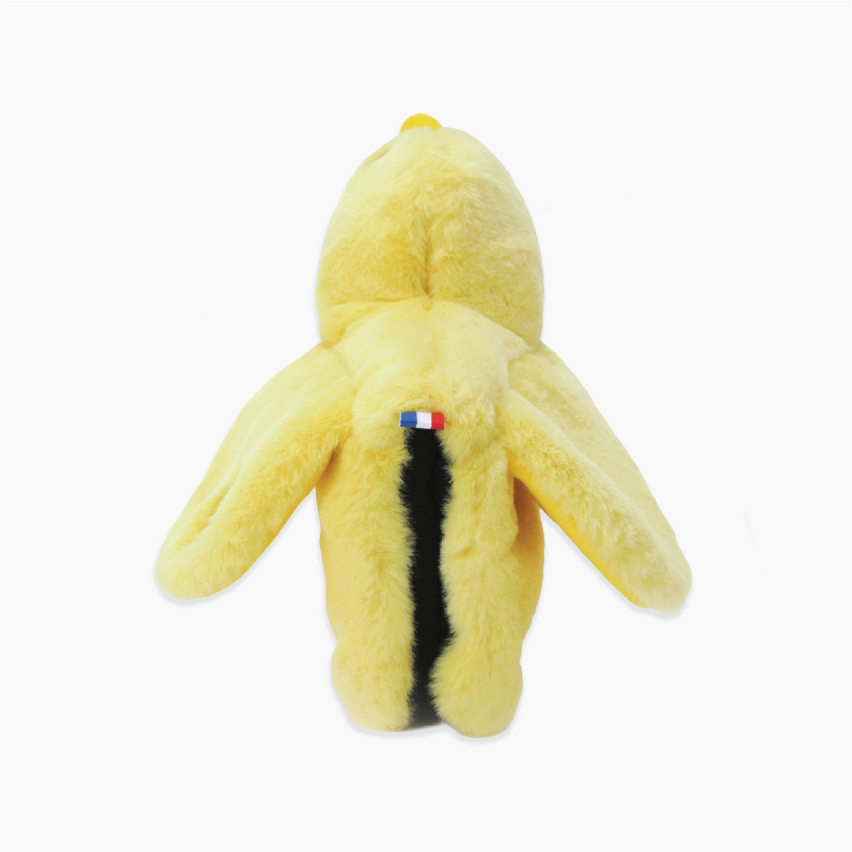 A yellow plush toy shaped like a penguin, shown from the back against a plain white background. It features a black vertical stripe down the center and a small French flag patch.