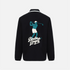 A black long-sleeve polo shirt shown from the back, featuring a teal and white graphic of a golfing player with the text &