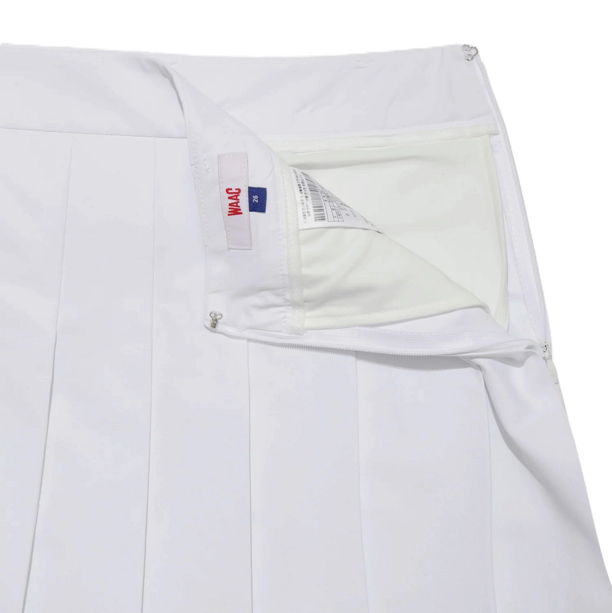 Close-up of white golf skort interior with zippered pocket