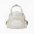 An off-white faux leather golf bag with dual top handles, side pockets, and a prominent oval &