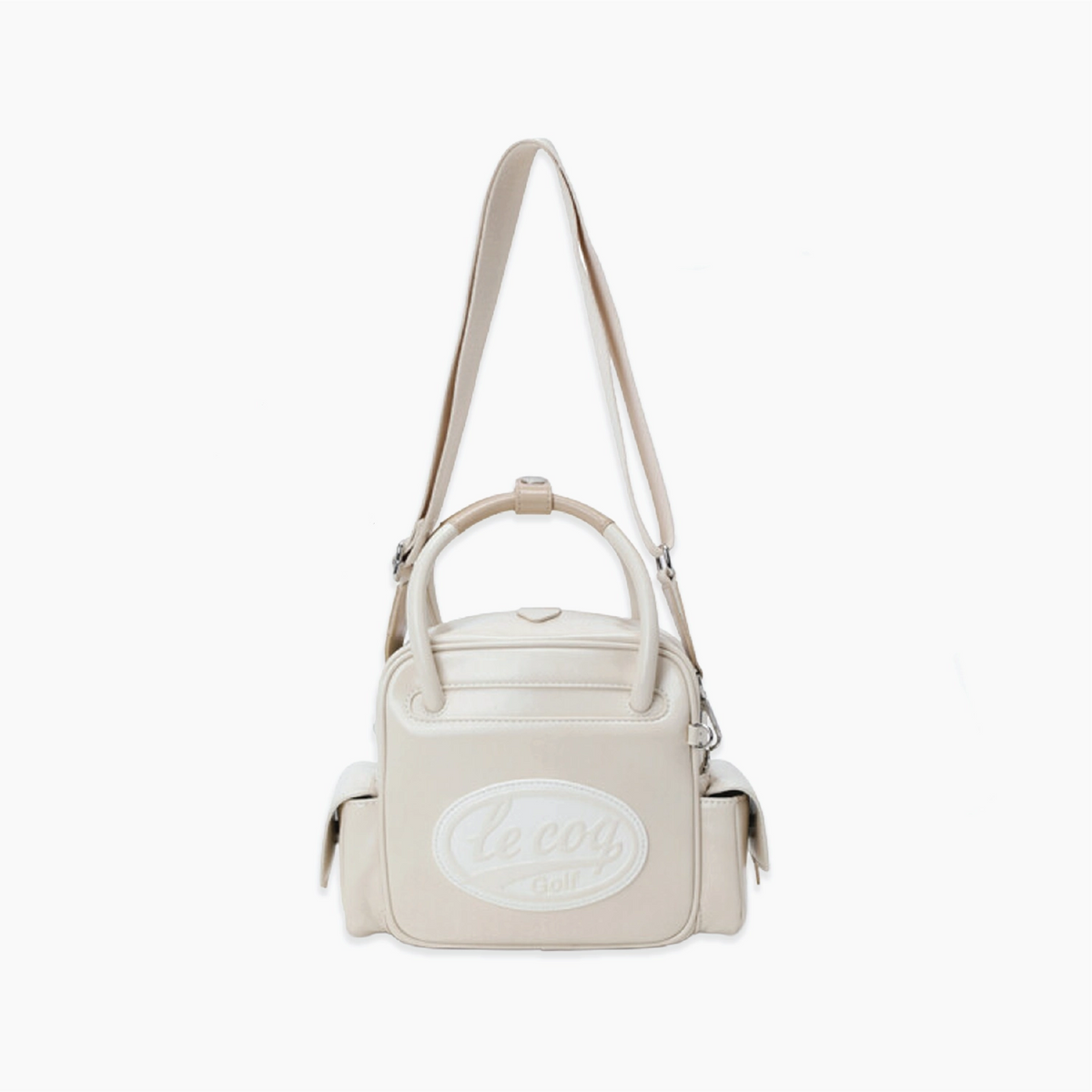 A cream-colored leather handbag with a top handle, shoulder strap, and a prominent oval 'Le coq Golf' logo patch on the front, set against a plain white background.