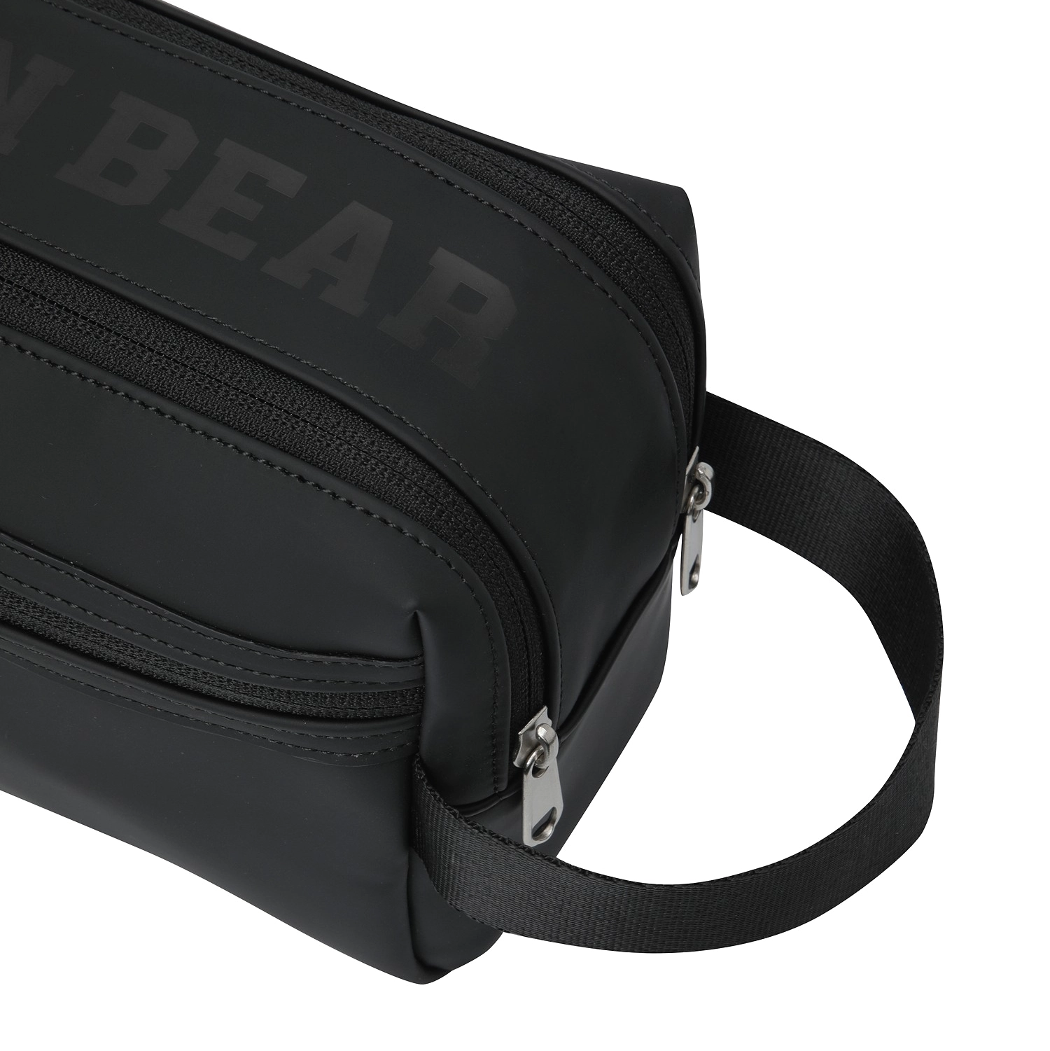 Close-up of a black crossbody bag with a tonal dark gray 'BEAR' logo on the side, featuring silver zippers and a black webbing strap on a white background.