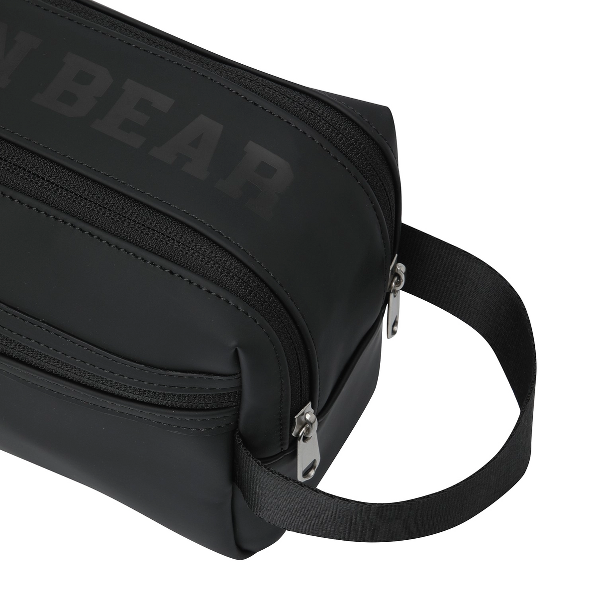 Close-up of a black crossbody bag with a tonal dark gray 'BEAR' logo on the side, featuring silver zippers and a black webbing strap on a white background.