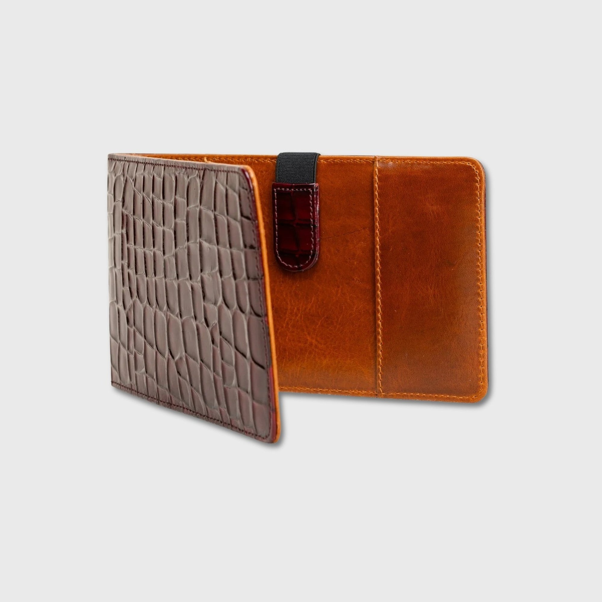 A brown leather yardage book holder shown open, featuring a textured crocodile-patterned front cover in a medium brown shade and a warm cognac brown interior with a dark brown strap closure.