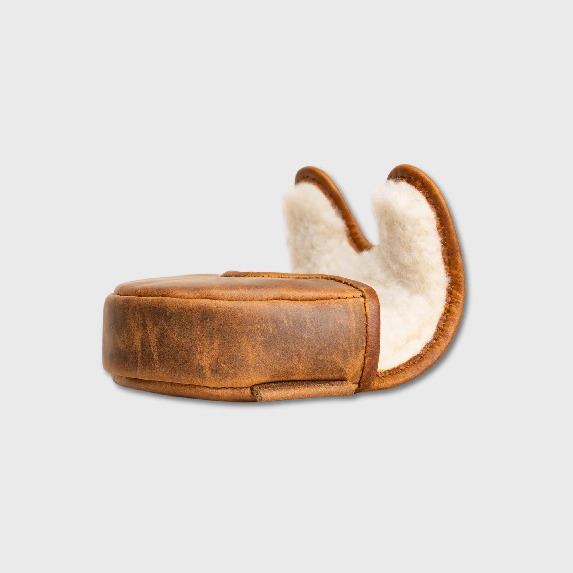 A brown leather OZ1 Putter Cover with a white shearling lining, shown from a side profile against a light gray background.