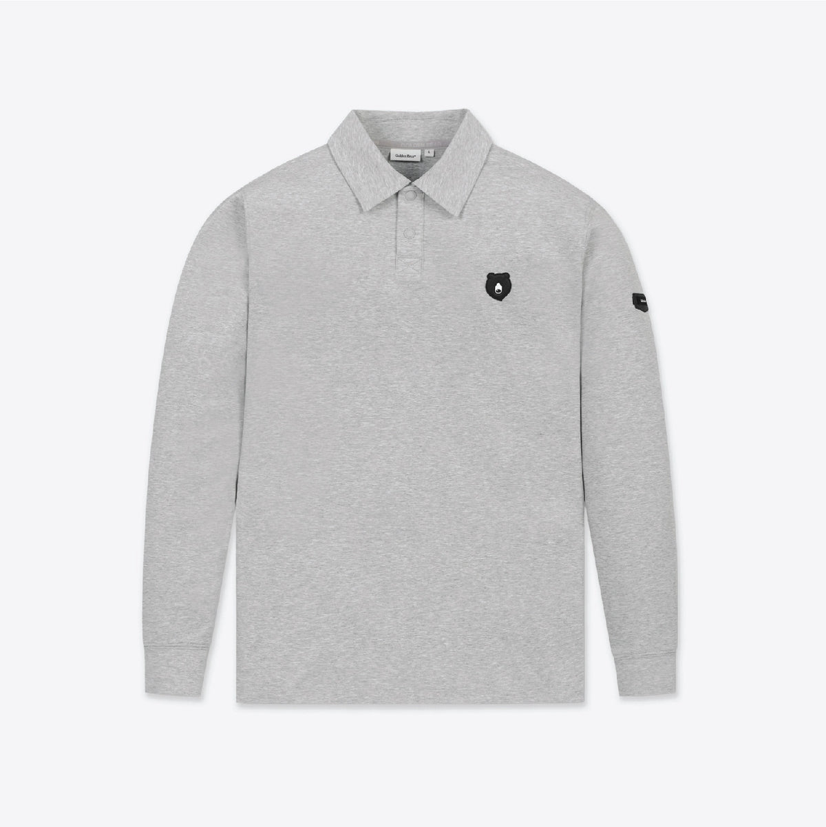 A light gray long-sleeve polo shirt with a small black shield logo on the left chest and a black logo patch on the right sleeve, shown against a plain light gray background.