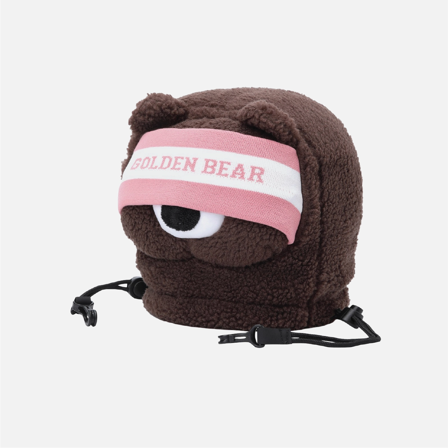 A brown plush bear-shaped headband or hat with a pink and white eye patch featuring the text 'GOLDEN BEAR' in pink, shown on a light gray background.