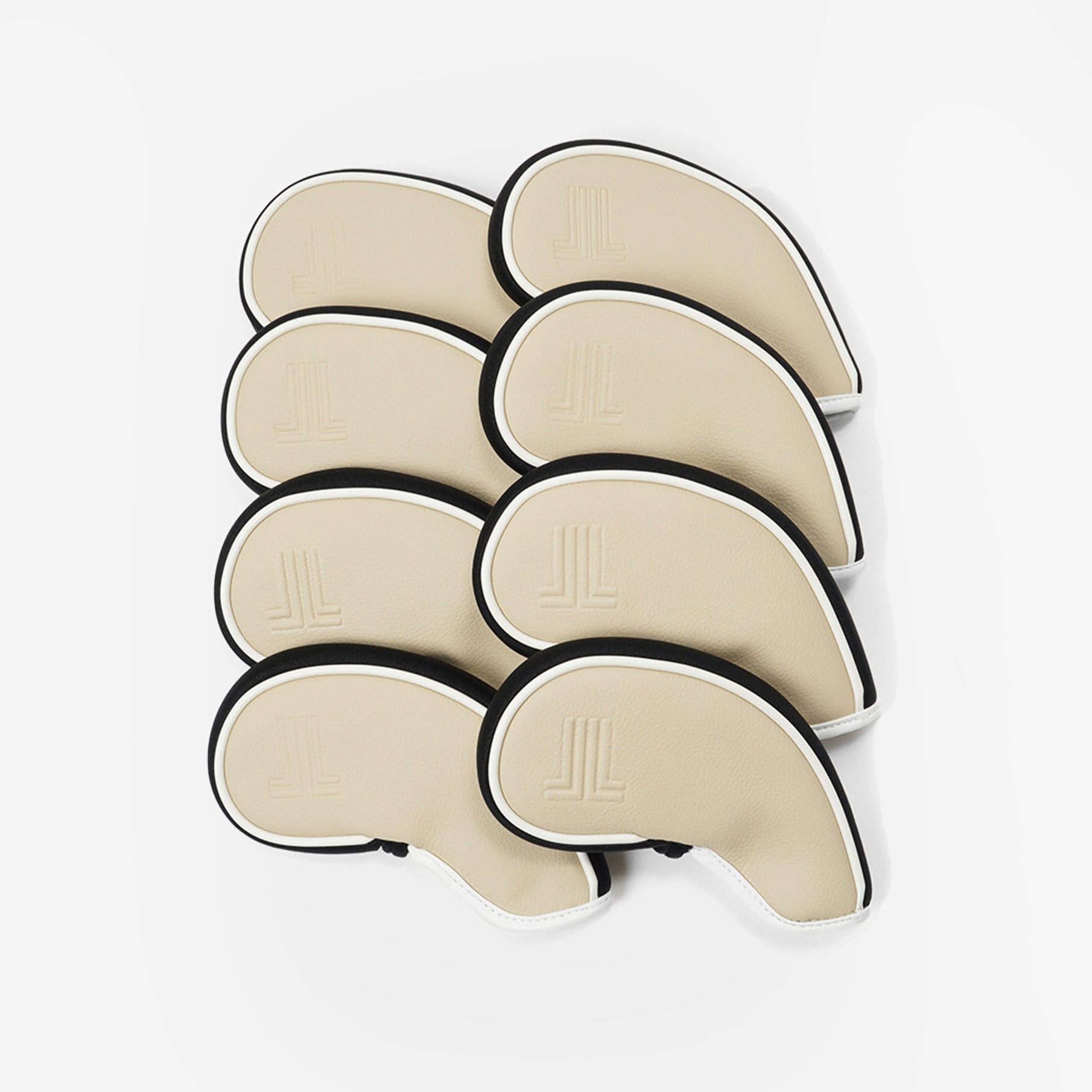 Set of beige golf covers with black edges on a white background