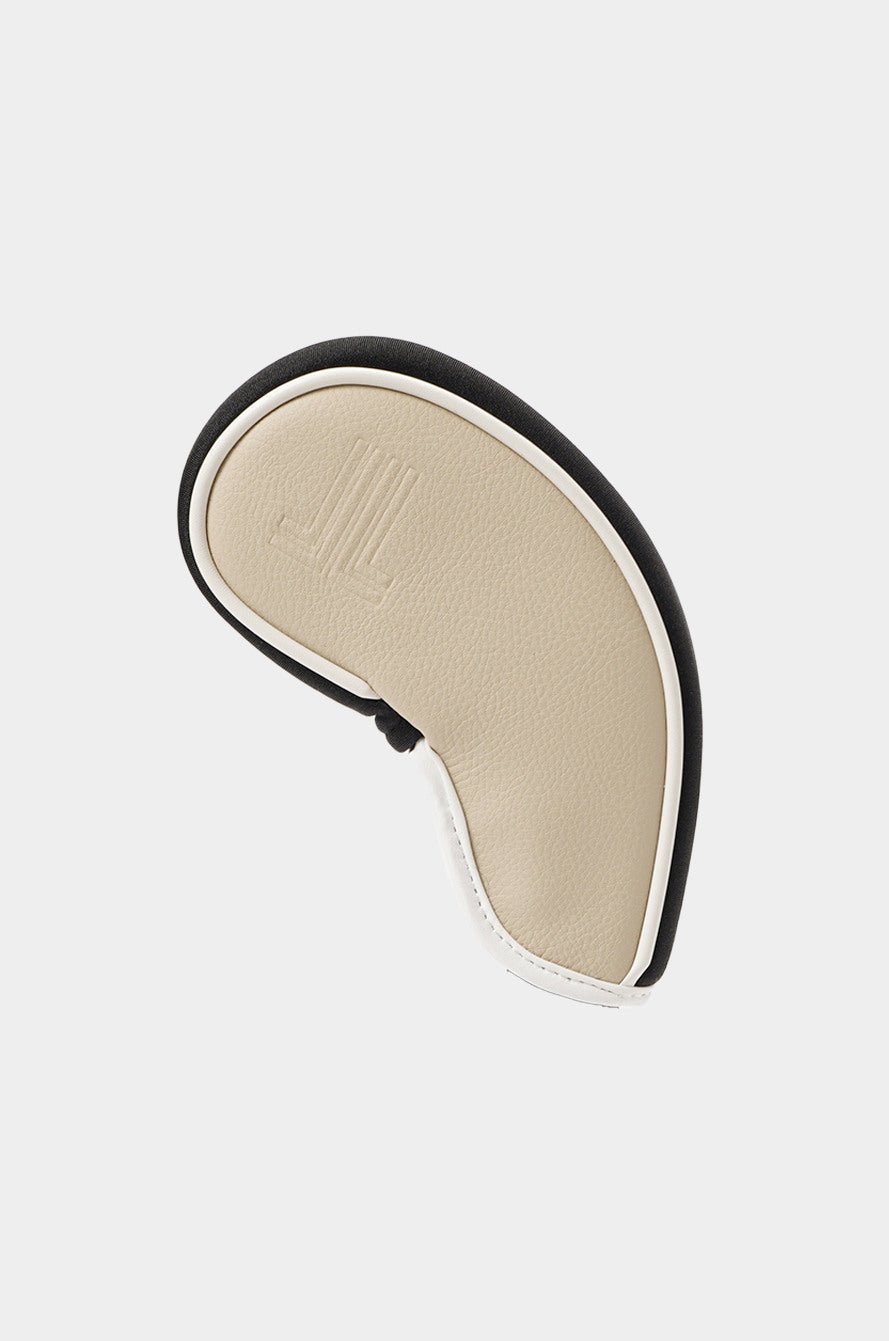 Beige and black shoe insole on a light gray background
