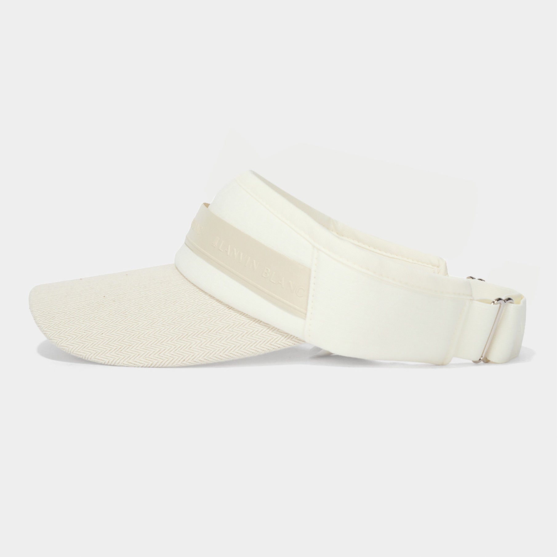 White visor cap with a strap on a light gray background