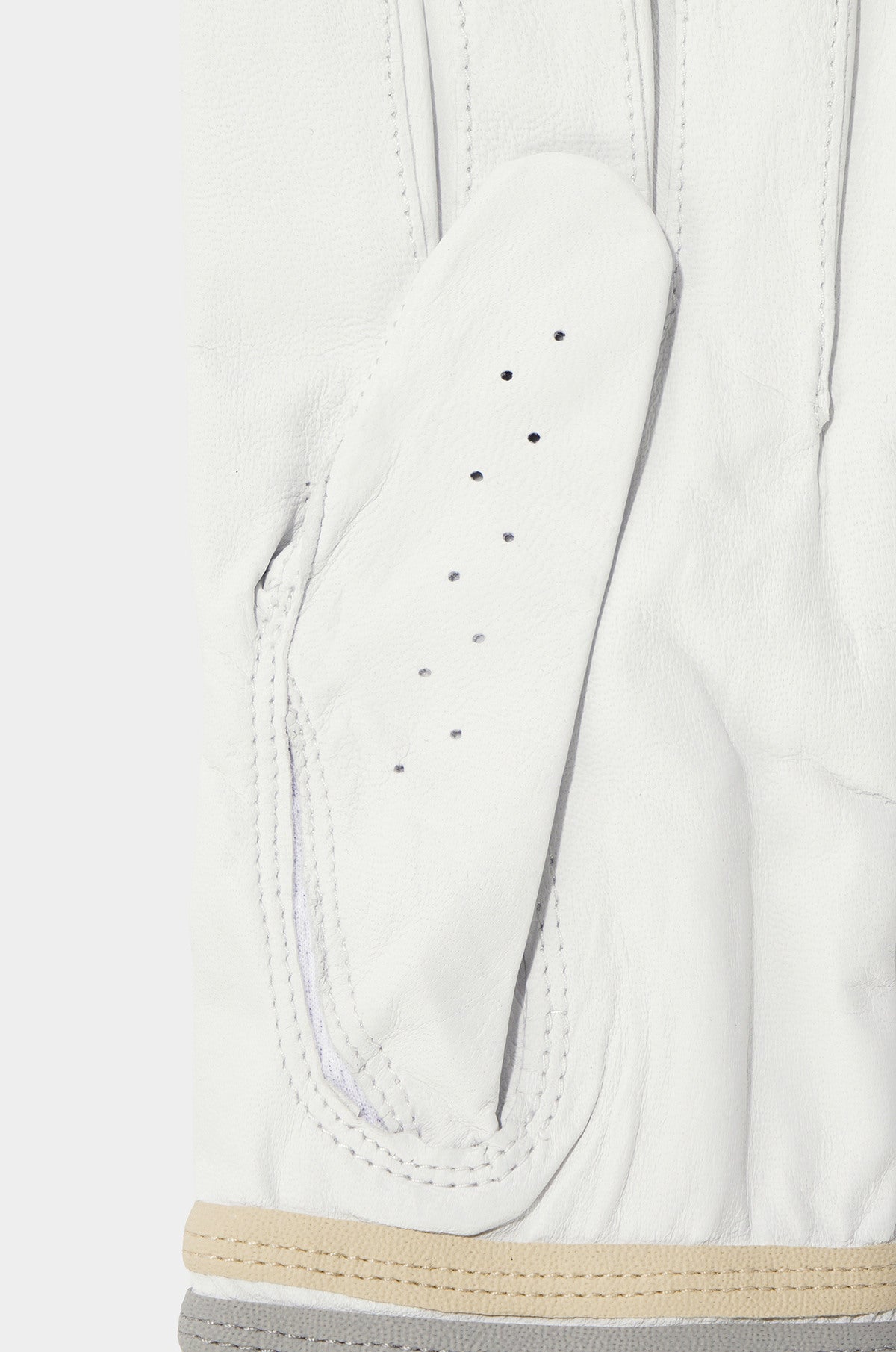 Close-up of a white leather glove with beige trim on a white background