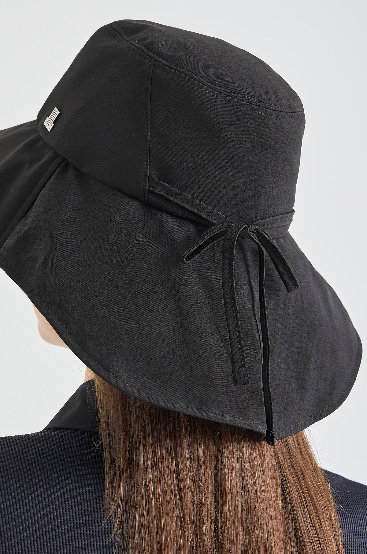 Black sun hat with a bow on a white background