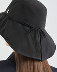 Black sun hat with a bow on a white background