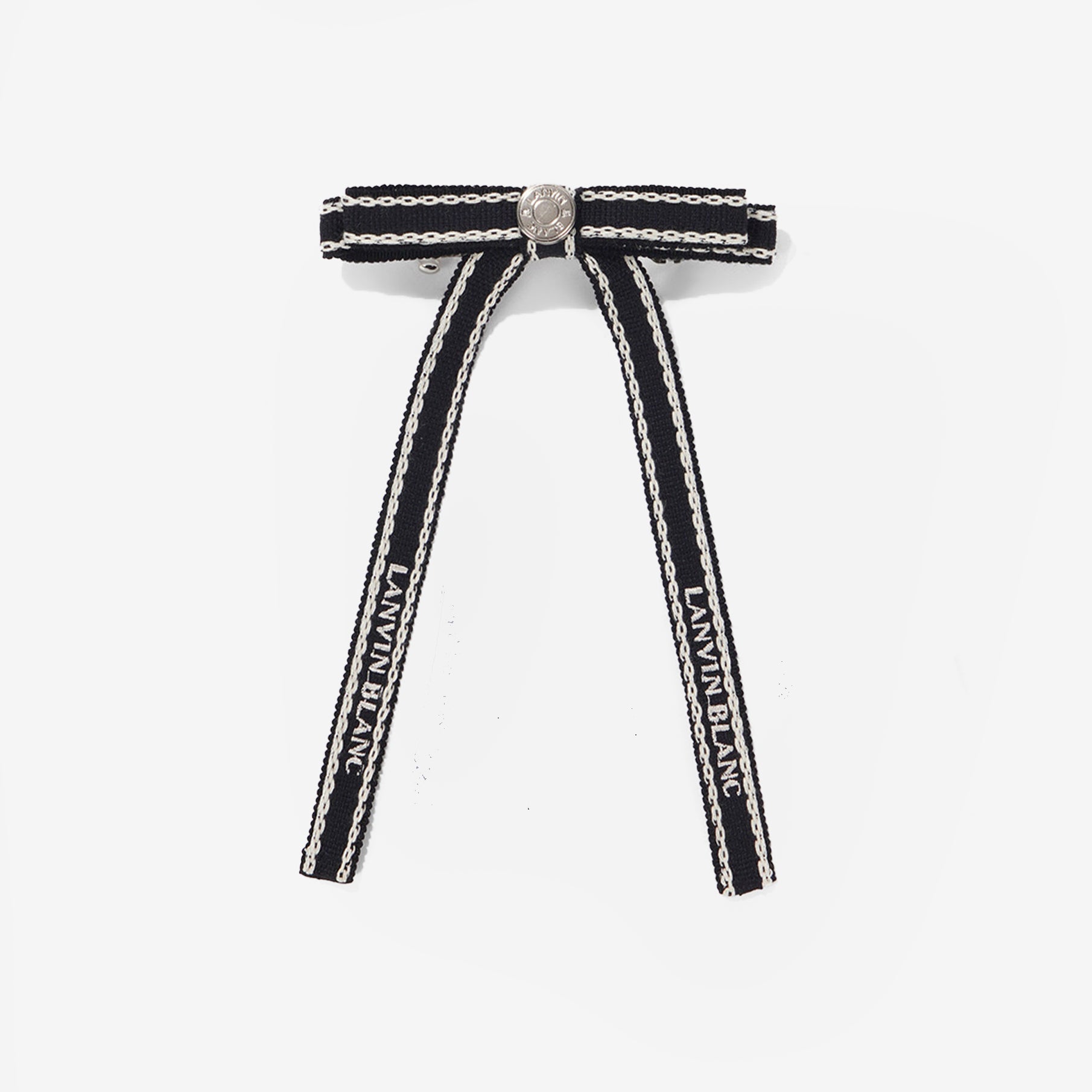 Black and white ribbon hair clip with 'LANVIN' branding on a light gray background