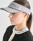 Person wearing a gray visor with a brand logo on a white background