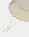Beige bucket hat with a chin strap on a white background