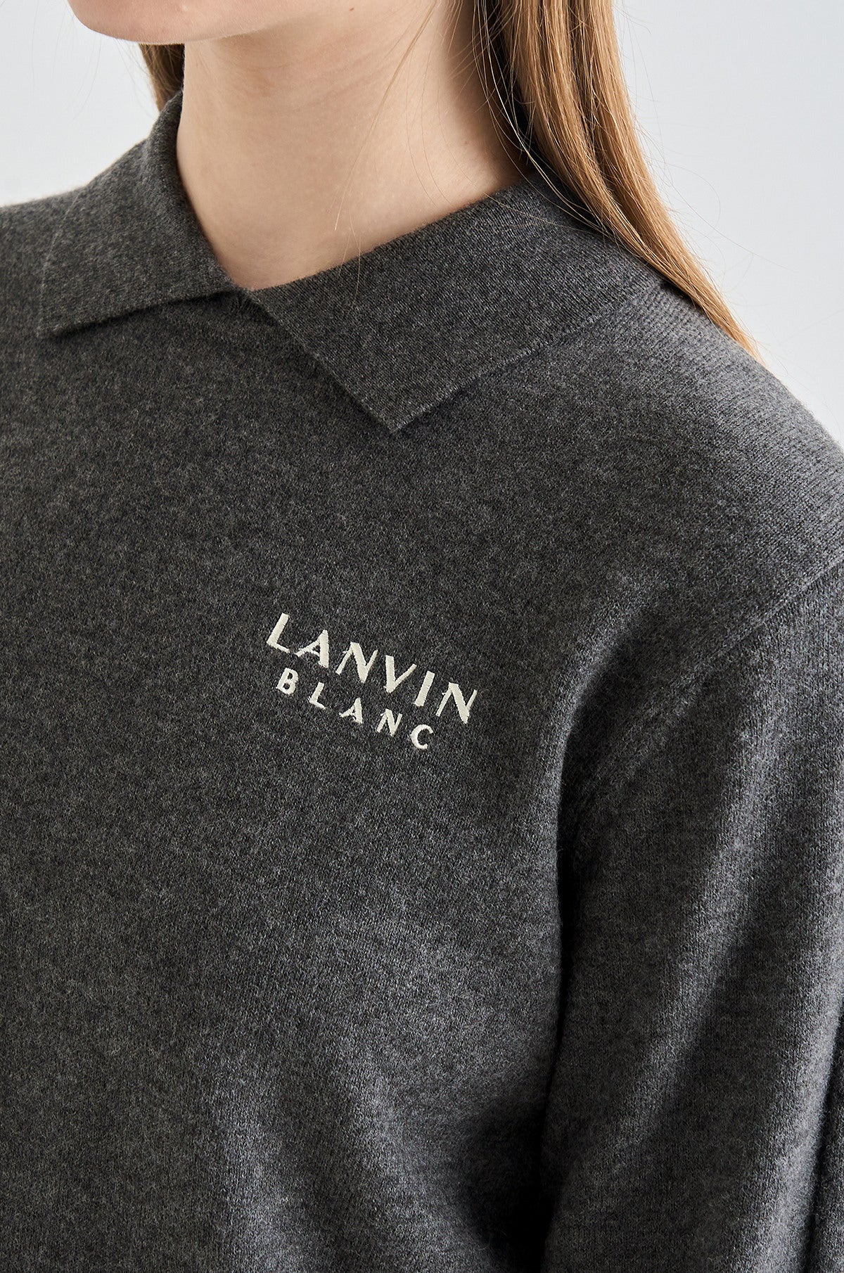 Dark gray polo shirt with 'LANVIN BLANC' logo on a plain background