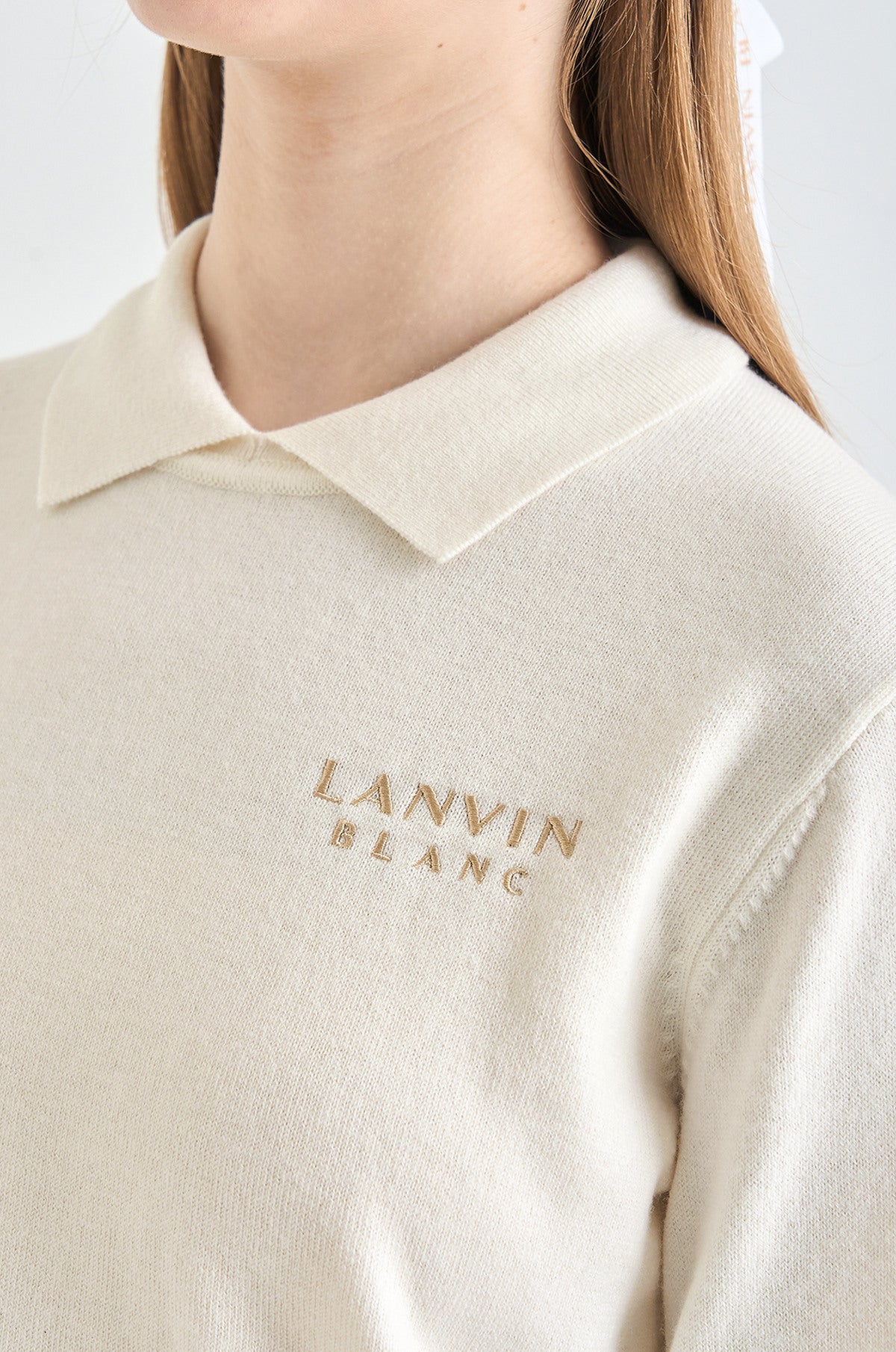 Beige polo shirt with 'LANVIN BLANC' embroidery on a plain background