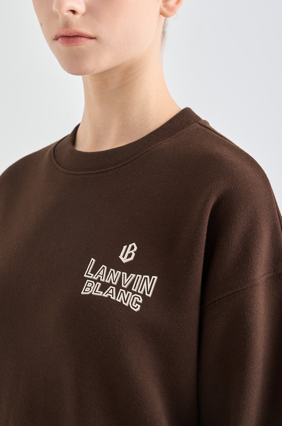 Brown sweatshirt with 'Lanvin Blanc' logo on a plain background