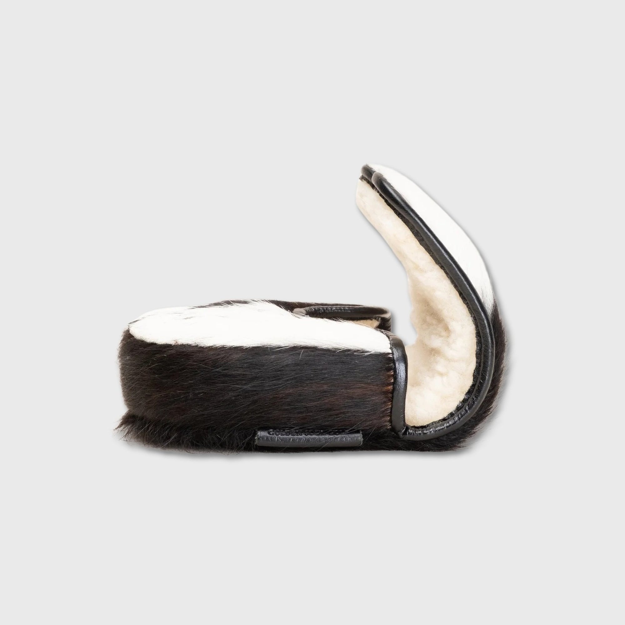 A Center DF3 Putter Cover made from cowhide, featuring a dark brown and black hide exterior with a soft cream-colored shearling lining, shown open against a light gray background.