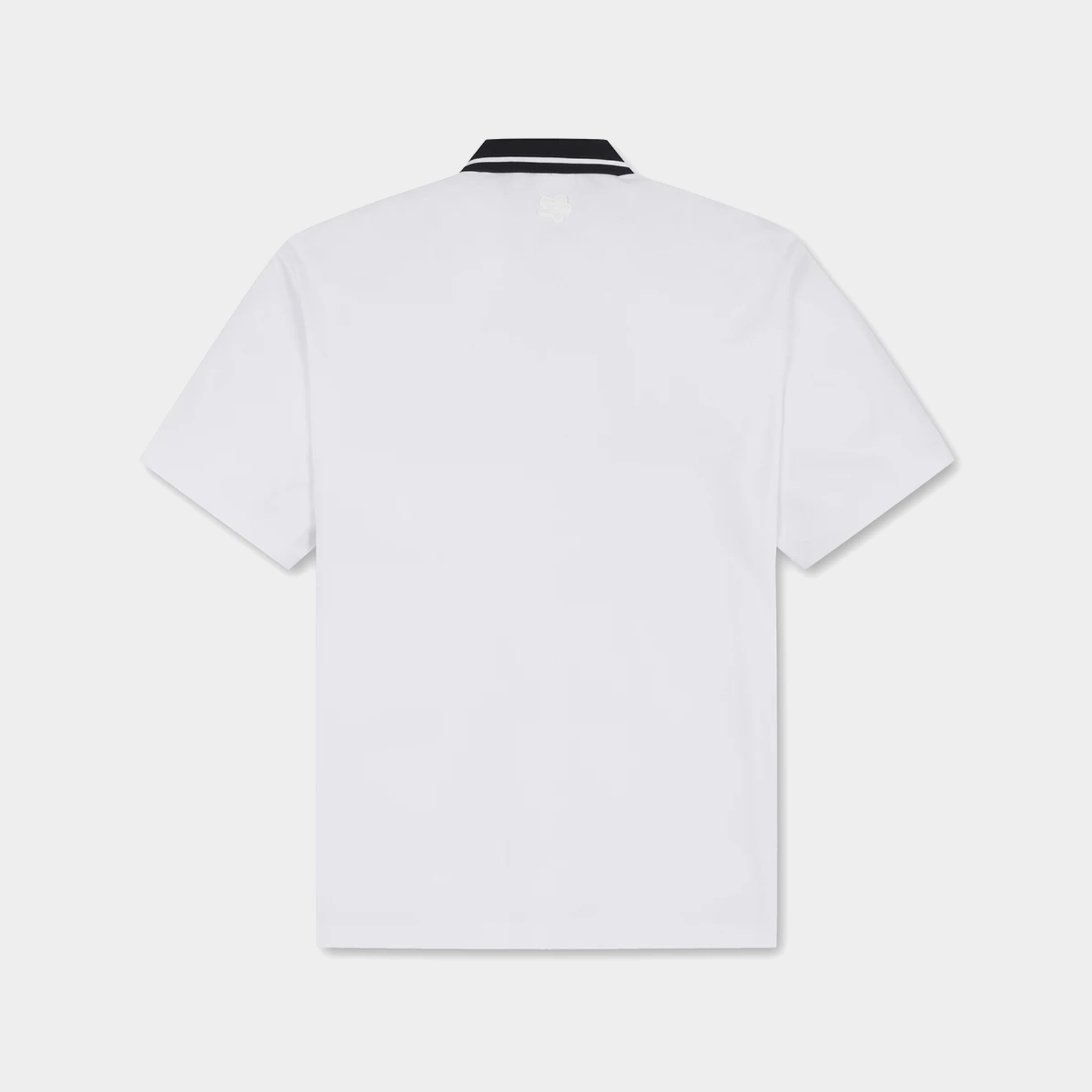 White short-sleeve polo shirt shown from the back, featuring a black and white striped collar, on a light gray background.