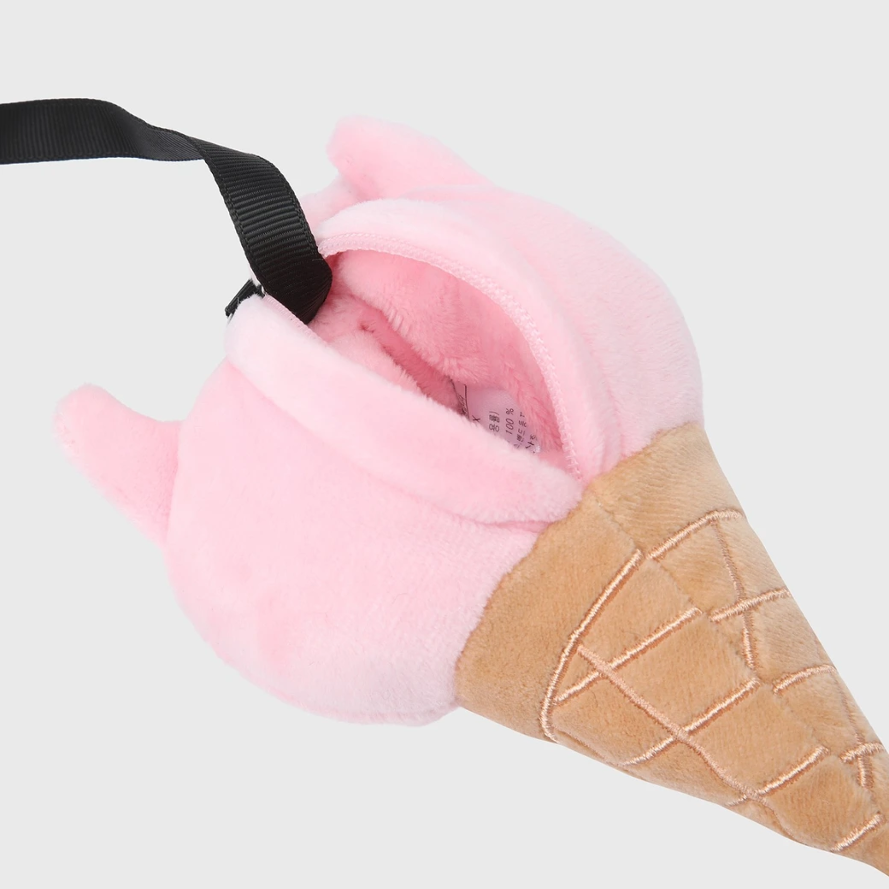 A plush ice cream cone-shaped pouch in pink and tan, with a black ribbon strap, shown on a light gray background.