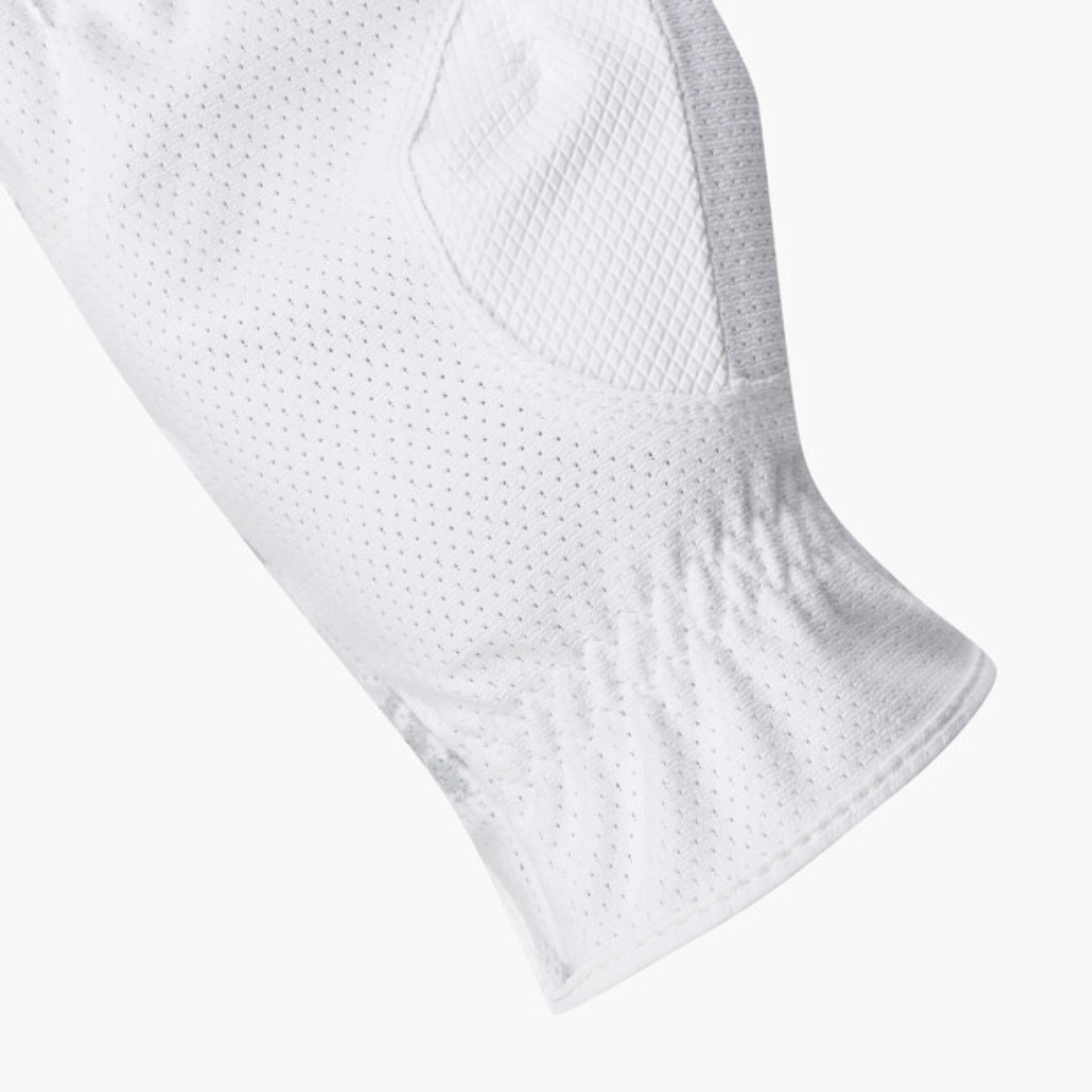 Close-up of a white athletic sleeve or glove with a breathable perforated mesh texture and ribbed cuff, shown on a light gray background.
