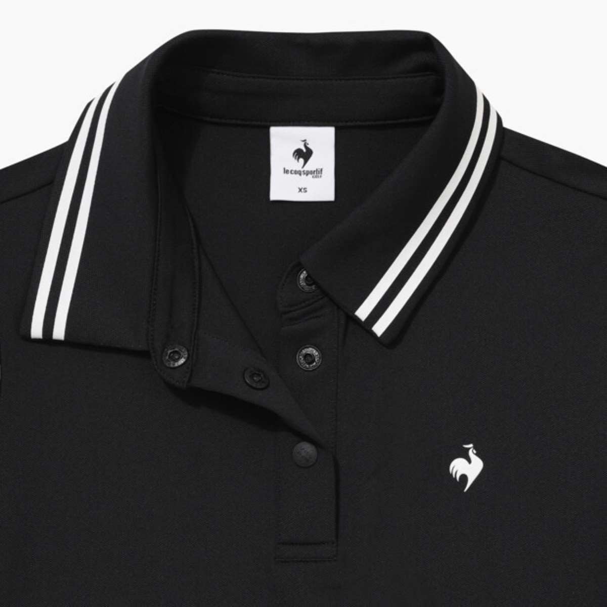 Close-up of a black polo shirt collar with white double stripes, featuring a white embroidered rooster logo on the chest and a brand label inside the collar.
