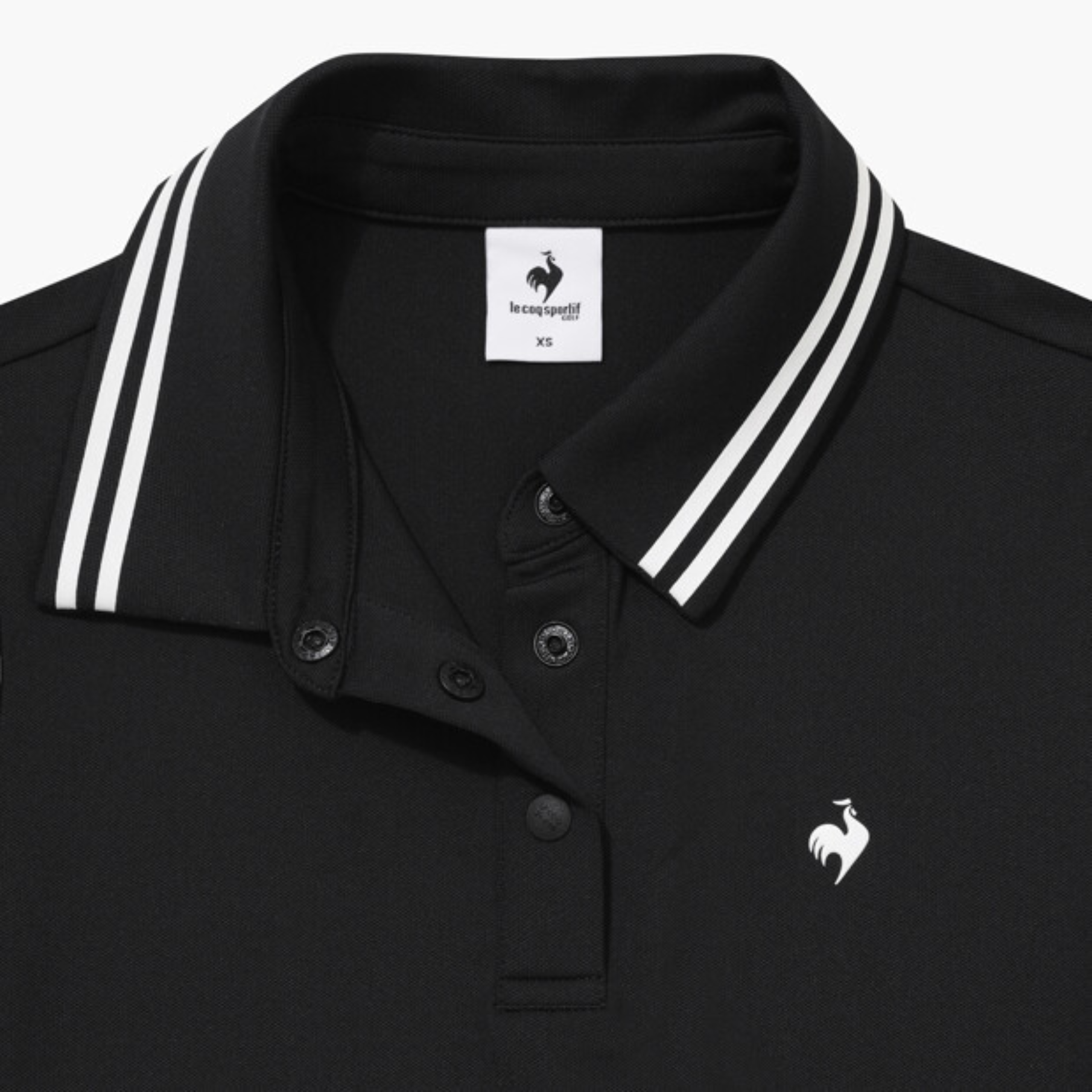 Close-up of a black polo shirt collar with white double stripes, featuring a white embroidered rooster logo on the chest and a brand label inside the collar.