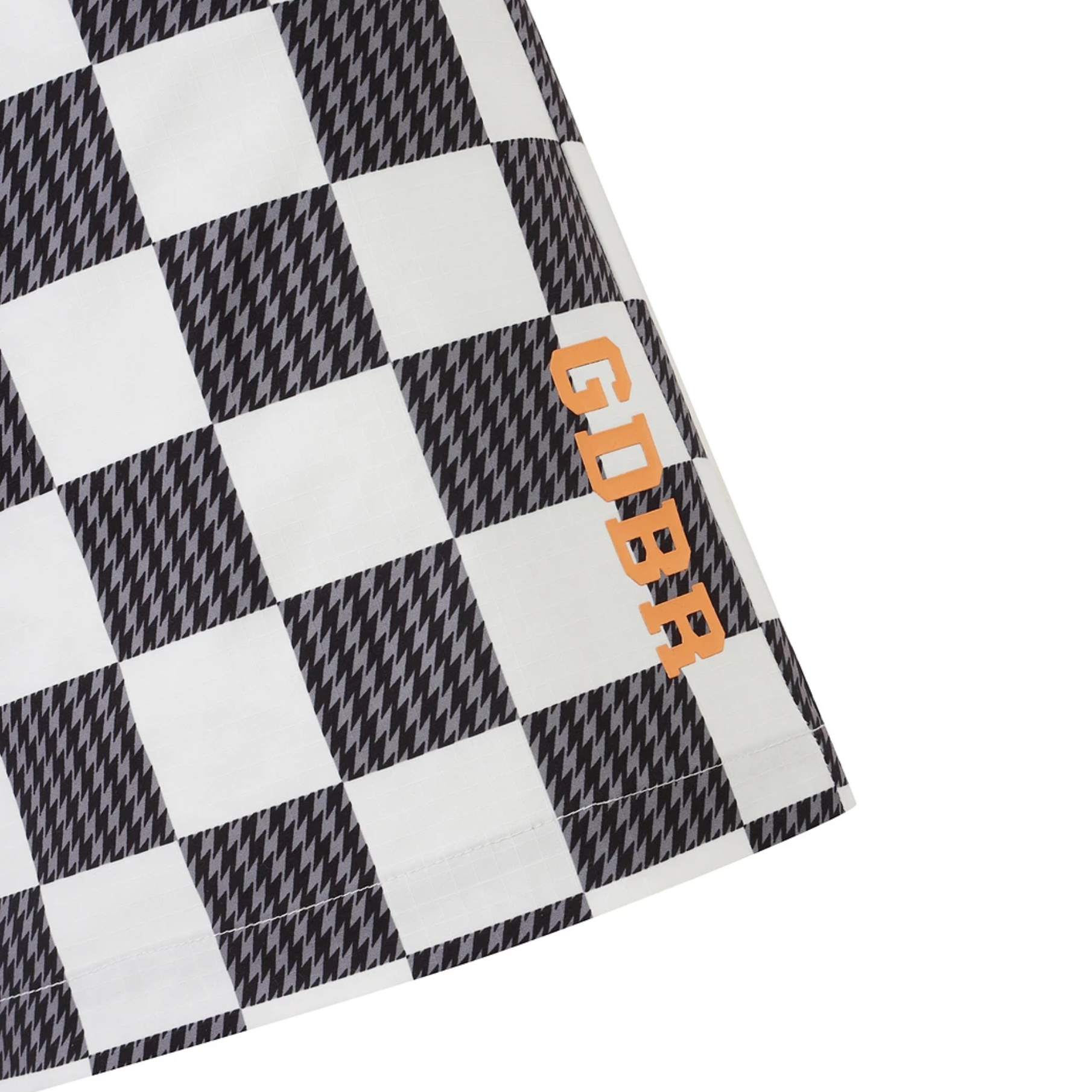 Close-up of a black and white checkered fabric product with the word 'GDBR' printed vertically in orange on the right side, photographed on a white background.