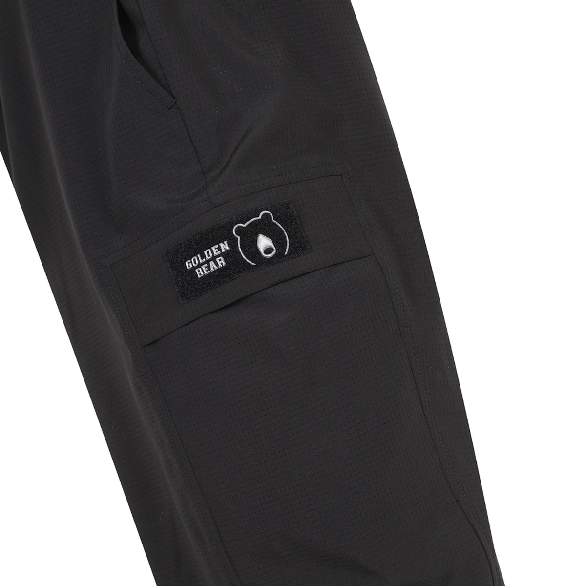 Close-up of cargo pocket with Golden Bear logo patch on men's black airdot cargo joggers.