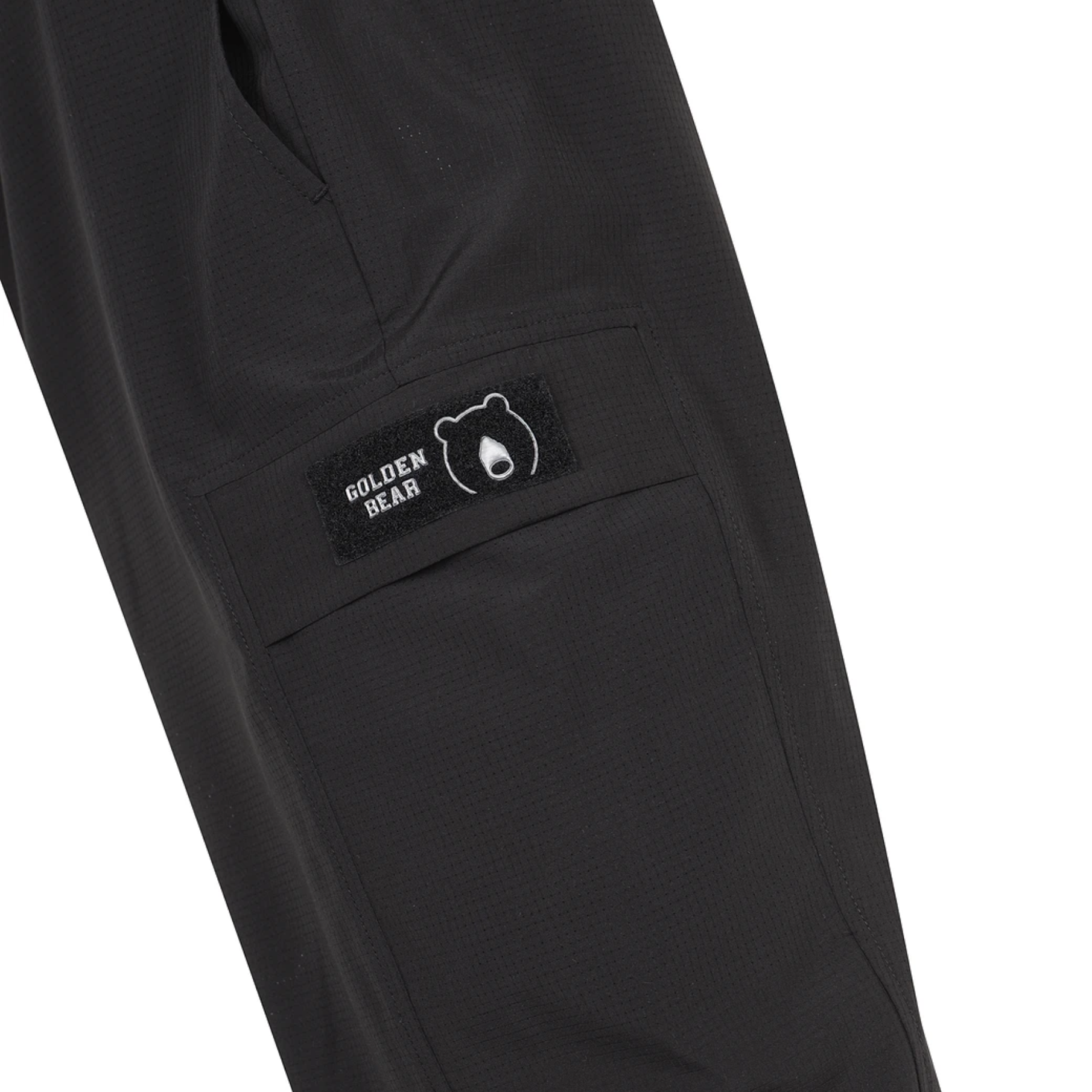 Close-up of cargo pocket with Golden Bear logo patch on men's black airdot cargo joggers.