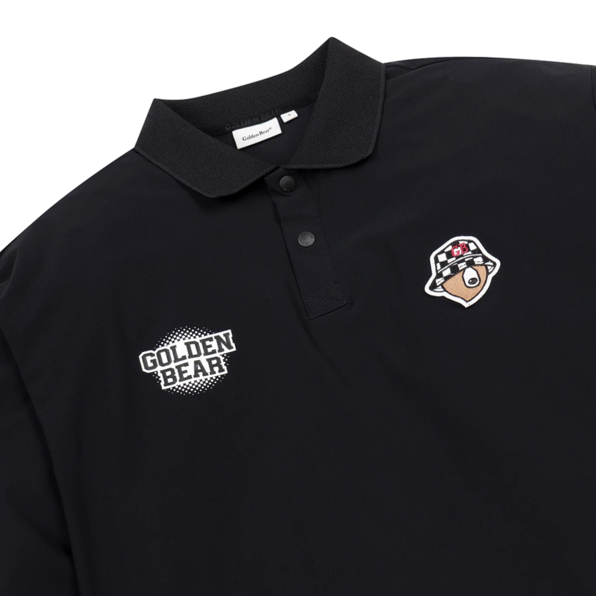 A close-up of a black polo shirt featuring a white 'GOLDEN BEAR' text patch on the right chest and a cartoon bear patch on the left chest, on a white background.