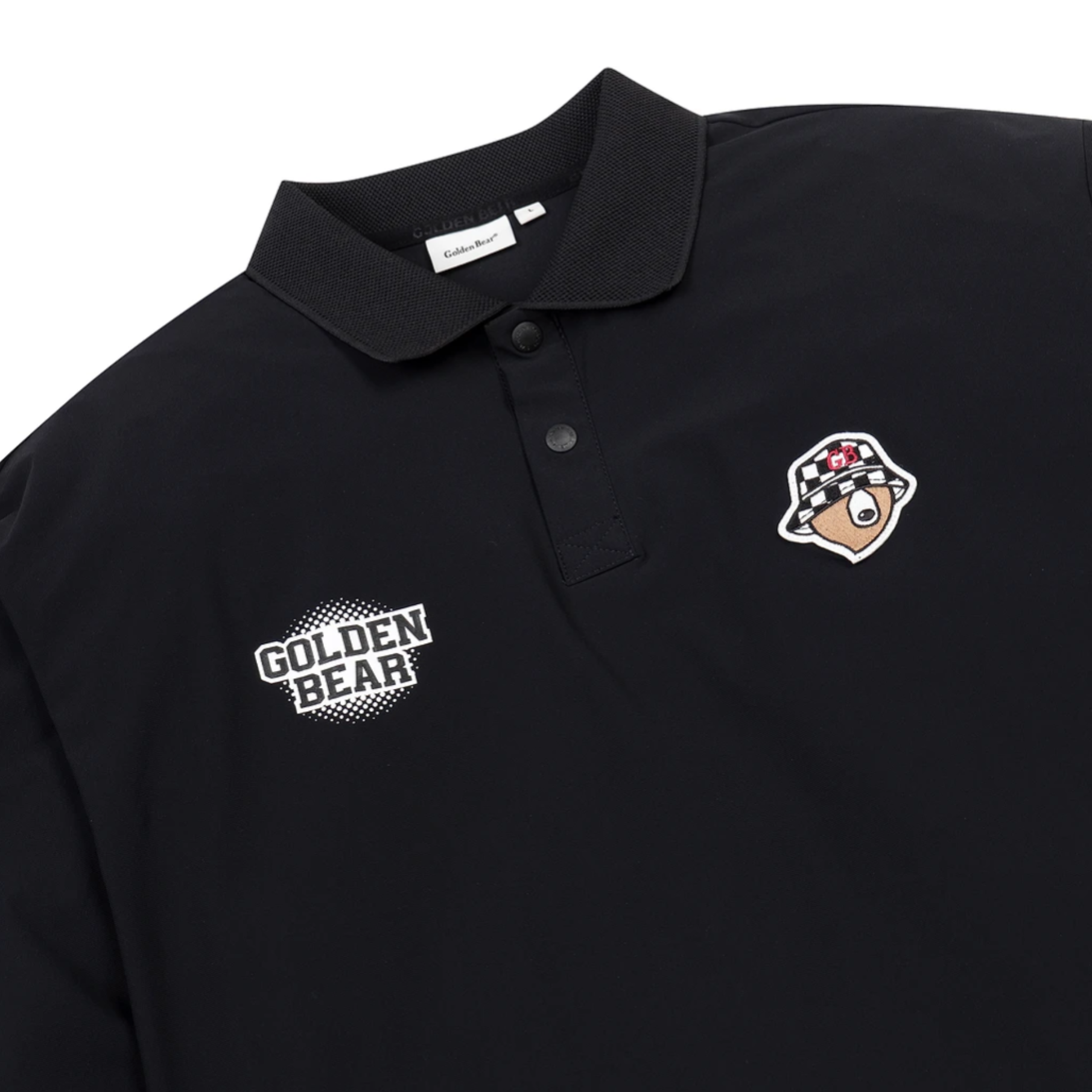 A close-up of a black polo shirt featuring a white 'GOLDEN BEAR' text patch on the right chest and a cartoon bear patch on the left chest, on a white background.